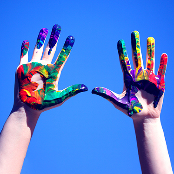 Immagine principale della pagina rappresenta il palmo delle mani sporche dei colori di una tavolozza dei colori su uno sfondo di colore blu